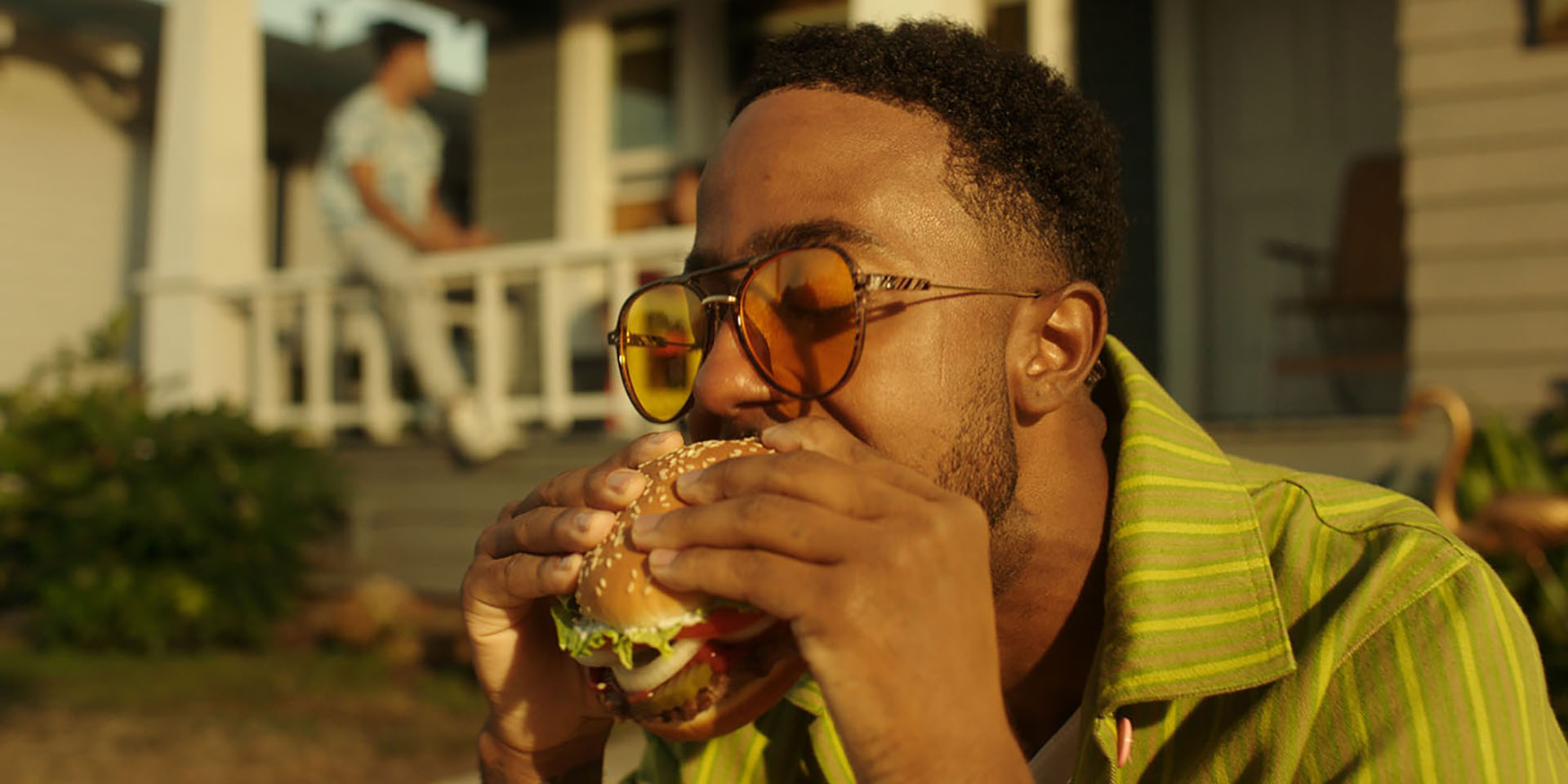 a man bites into a Burger King Whopper