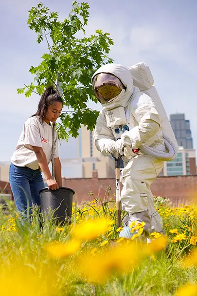 a man in an astronaut costume plants trees